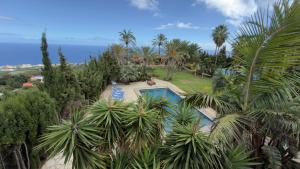 an aerial view of a resort with a pool and palm trees at Almabella in Breña Baja