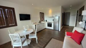 a kitchen and living room with a table and a couch at Almabella in Breña Baja