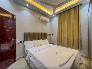 a bedroom with a large white bed and a window at 129 · 2BR Townhouse 2 Bath TV Backyard in Sheikh Zayed