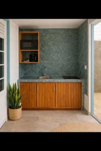 a kitchen with a sink and a counter top at L'ilot secret in Le Robert