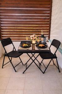 a table with two chairs and two plates of food at L'ilot secret in Le Robert