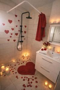 a bathroom with a shower with hearts on the floor at L'ilot secret in Le Robert
