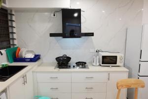 a kitchen with a counter top with a microwave at Nadi Easy Stay Near McDonalds in Nadi