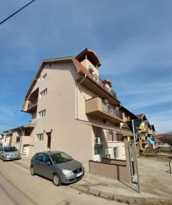 a building with a car parked in front of it at Apartman Brankovic in Jagodina