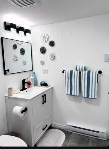 a white bathroom with a sink and a mirror at Harrison Lakeside Retreat in Harrison Hot Springs +32 photos