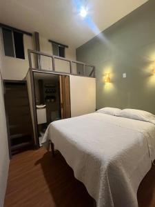 a bedroom with a large white bed in a room at Casa Luna Bonita in Cabo San Lucas