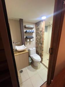 a bathroom with a toilet and a sink and a shower at Casa Luna Bonita in Cabo San Lucas