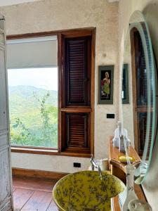 a bathroom with a sink and a window at The Chaisai Private Lodge in Ban Huai San Mai