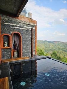a house with a swimming pool on top of the water at The Chaisai Private Lodge in Ban Huai San Mai +12 photos