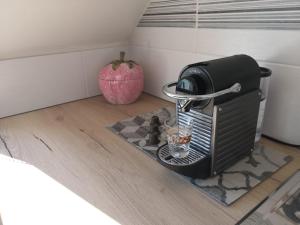 a toaster sitting on the floor with an apple in the corner at Cosy Aix in Aix-les-Bains