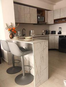 a kitchen with a counter with wine glasses on it at Magica Cartagena Suite in Cartagena de Indias