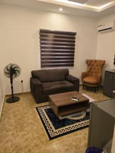 a living room with a couch and a coffee table at Rehoboth in Mama