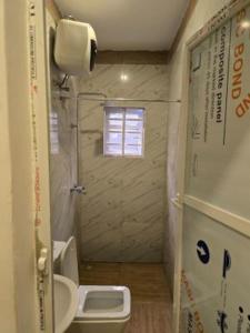 a small bathroom with a toilet and a sink at Rehoboth in Mama