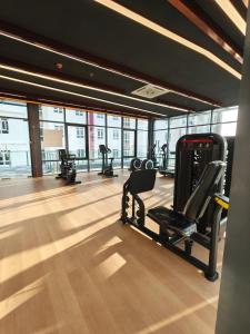 a gym with treadmills and ellipticals in a building at Mesahill Premier Suite-Wi-Fi-NETFLIX in Nilai