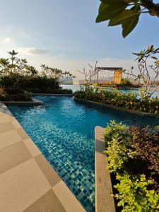 a resort swimming pool with a view of the ocean at Mesahill Premier Suite-Wi-Fi-NETFLIX in Nilai