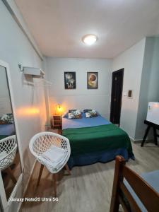 a bedroom with a bed and two chairs in it at THEHotelBoutiqueCidadeVelha in Belém