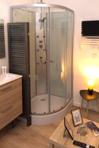 a bathroom with a shower with a sink and a table at Kait location in Pont-sur-Yonne +76 photos