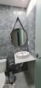 a bathroom with a mirror and a sink at THEHotelBoutiqueCidadeVelha in Belém