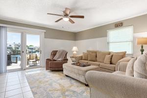 a living room with a couch and a ceiling fan at Allendale Docks in Destin
