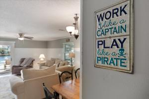 a living room with a table and a dining room at Allendale Docks in Destin