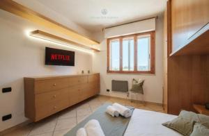 a bedroom with a bed and a dresser at Dimora Karalis in Cagliari