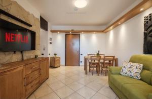 a living room with a couch and a tv and a table at Dimora Karalis in Cagliari +5 photos