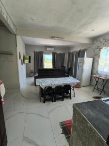 a living room with a table and a refrigerator at Varanda do Céu Paraty in Paraty +3 photos