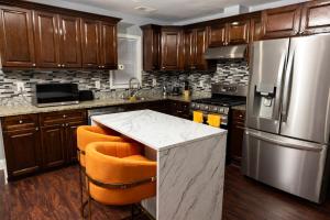 a kitchen with wooden cabinets and a stainless steel refrigerator at Airende in Newark