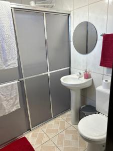 a bathroom with a shower and a toilet and a sink at Espaço para Hermanos in São Gabriel