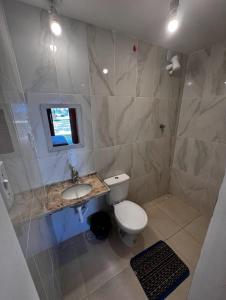 a bathroom with a toilet and a sink at BRKITE Pousada in Cumbuco +9 photos