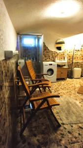 two wooden chairs sitting in a kitchen with a appliance at Souterrainwohnung in Niederau in Niederau