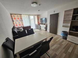 a living room with a table and chairs at King Apartment Luftkurort Bayerischen Wald in Sankt Englmar