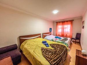 a bedroom with two beds and a couch at Family holiday home new beds in Bragança +6 photos