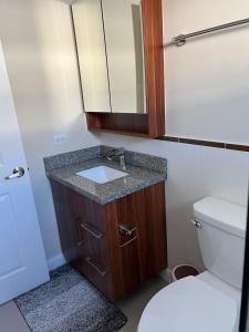 a bathroom with a sink and a toilet at Gate home by ocean point in Lucea +24 photos