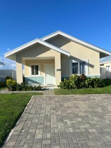 a house with a brick driveway in front of it at Gate home by ocean point in Lucea