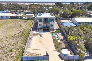 an aerial view of a white house on a hill at Wheeler's Paradise in Paradise Beach