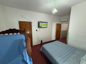 a room with two beds and a tv on the wall at Nido Urbano in San Luis