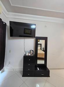 a bathroom with a black dresser and a mirror at Mi Cassa Real Degollado Hotel #4 in Degollado