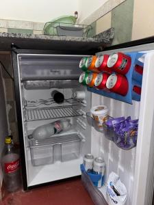an open refrigerator filled with lots of food and drinks at Nido Urbano in San Luis