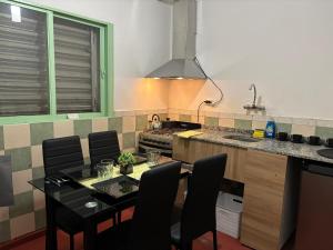 a kitchen with a table with chairs and a stove at Nido Urbano in San Luis