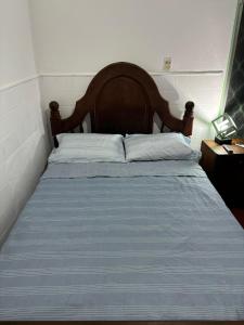 a bedroom with a bed with a wooden headboard at Nido Urbano in San Luis +6 photos