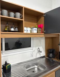 a kitchen with a sink and a counter top at Casa Verde próxima a BR 290 in São Gabriel +17 photos