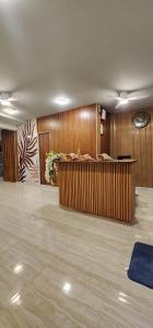 a lobby with wooden walls and a reception desk at Havaa Inn Dhangethi in Dhangethi