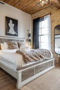 a bedroom with a large bed and a window at Bradshaw Lofts The Brixton King Suite in Stratford