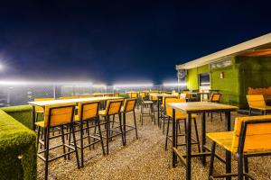 a row of tables and chairs on a patio at Townhouse Oak Silver City Chowk Formerly HW Residency in Dehradun