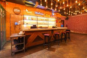 a bar in a restaurant with bar stools at Townhouse Oak Silver City Chowk Formerly HW Residency in Dehradun