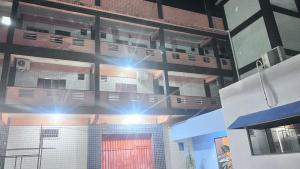 a building with lights on top of it at Braz Hotel in Tomé-Açu