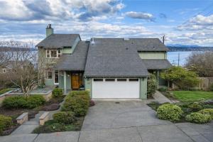 a green house with a white garage at Seasons at Leschi Hillsides in Seattle