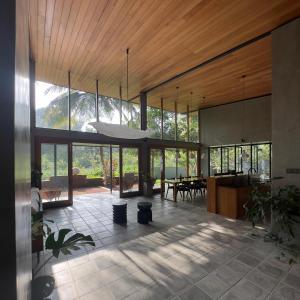 a large room with glass doors and a ceiling at Clover Bentota in Dedduwa