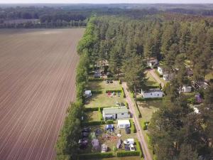 an aerial view of a farm next to a field at 6-Guest Escape with Private Garden & Wi-Fi in Overbroek +14 photos